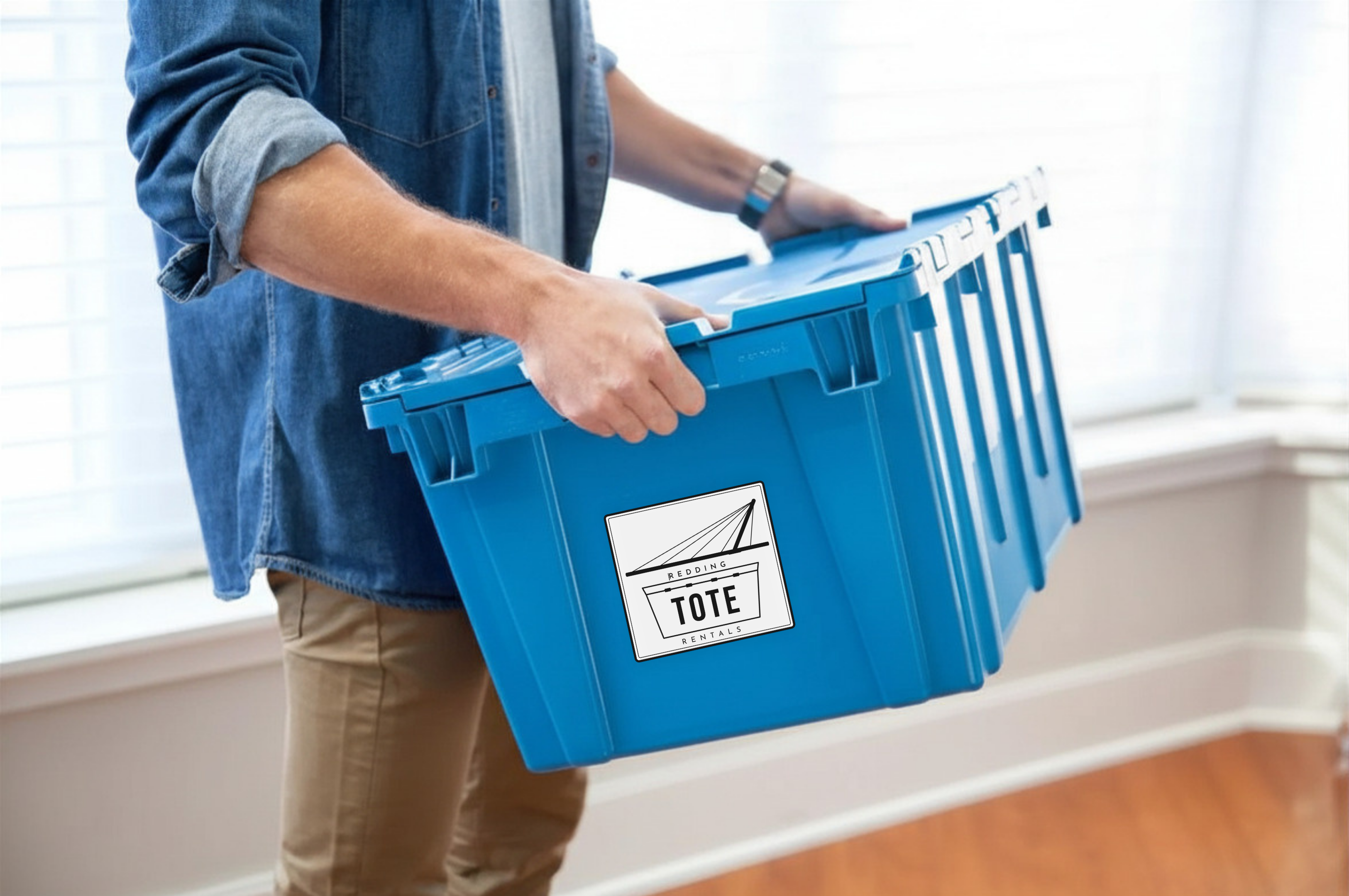 Person carrying a Redding Tote Rentals heavy-duty moving tote